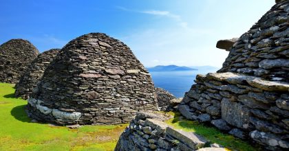 shutterstock 1469160323 1 scaled Stone beehive huts overlook the sea—book your Dingle Peninsula tour online for stunning views.