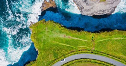 pOdWisJ Aerial view of a car on the Wild Atlantic Way during a Dingle Peninsula private day tour.