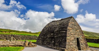 shutterstock 470786339 scaled Ancient stone building on the Slea Head drive tour from Dingle, set in a grassy rural landscape.