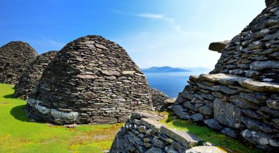 Stone beehive huts overlook the sea—book your Dingle Peninsula tour online for stunning views.