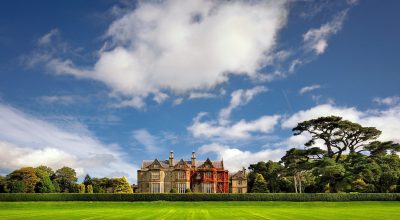 Large historic mansion on a lawn, perfect stop on a Slea Head drive tour from Dingle.