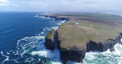 Aerial view of Irish cliffs and lighthouse on a Wild Atlantic Way private tour Dingle.