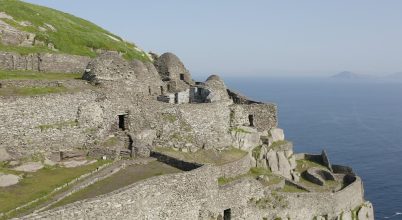 Stone beehive huts on a cliffside—book a Dingle Peninsula tour online to explore this view.